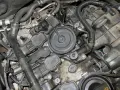 Silnik Audi z widocznymi cewkami zapłonowymi i elementami układu dolotowego, potencjalnie powiązany z błędem DTC P0171.