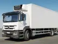 Biała chłodnia Mercedes Axor z agregatem Carrier na dachu, gotowa do transportu towarów.
