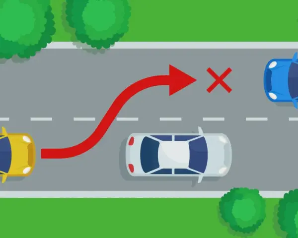 Żółty samochód próbuje niebezpiecznego **wymijania** niebieskiego auta, ignorując białe auto i czerwony znak zakazu.