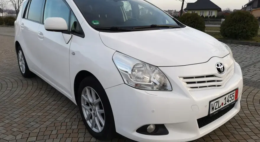 Biała Toyota Verso 1.8 benzyna zaparkowana na kostce brukowej.