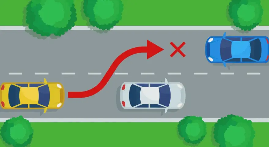 Żółty samochód próbuje niebezpiecznego **wymijania** niebieskiego auta, ignorując białe auto i czerwony znak zakazu.