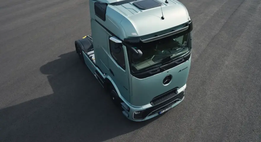 Nowy Mercedes Actros 2025 w kolorze miętowym prezentuje się na ciemnym asfalcie.